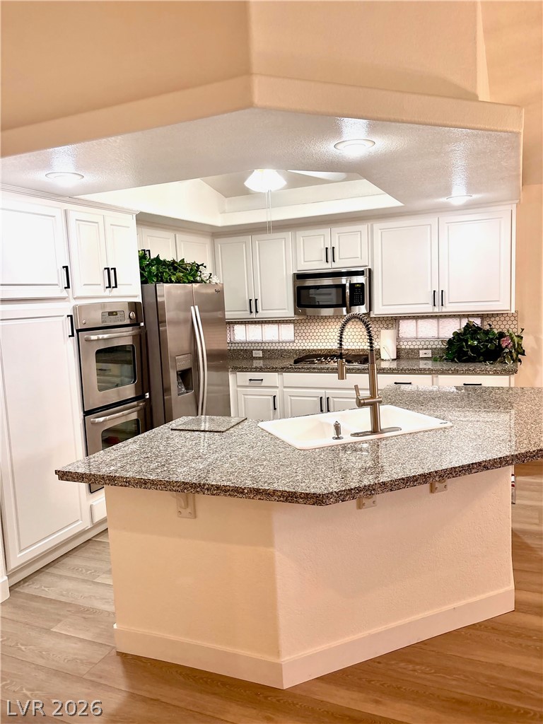 9040 Dove River Road Las Vegas, NV 89134 - Photo 4 of 22 Polished granite countertops and classic cabinetry anchor this well-appointed culinary space.