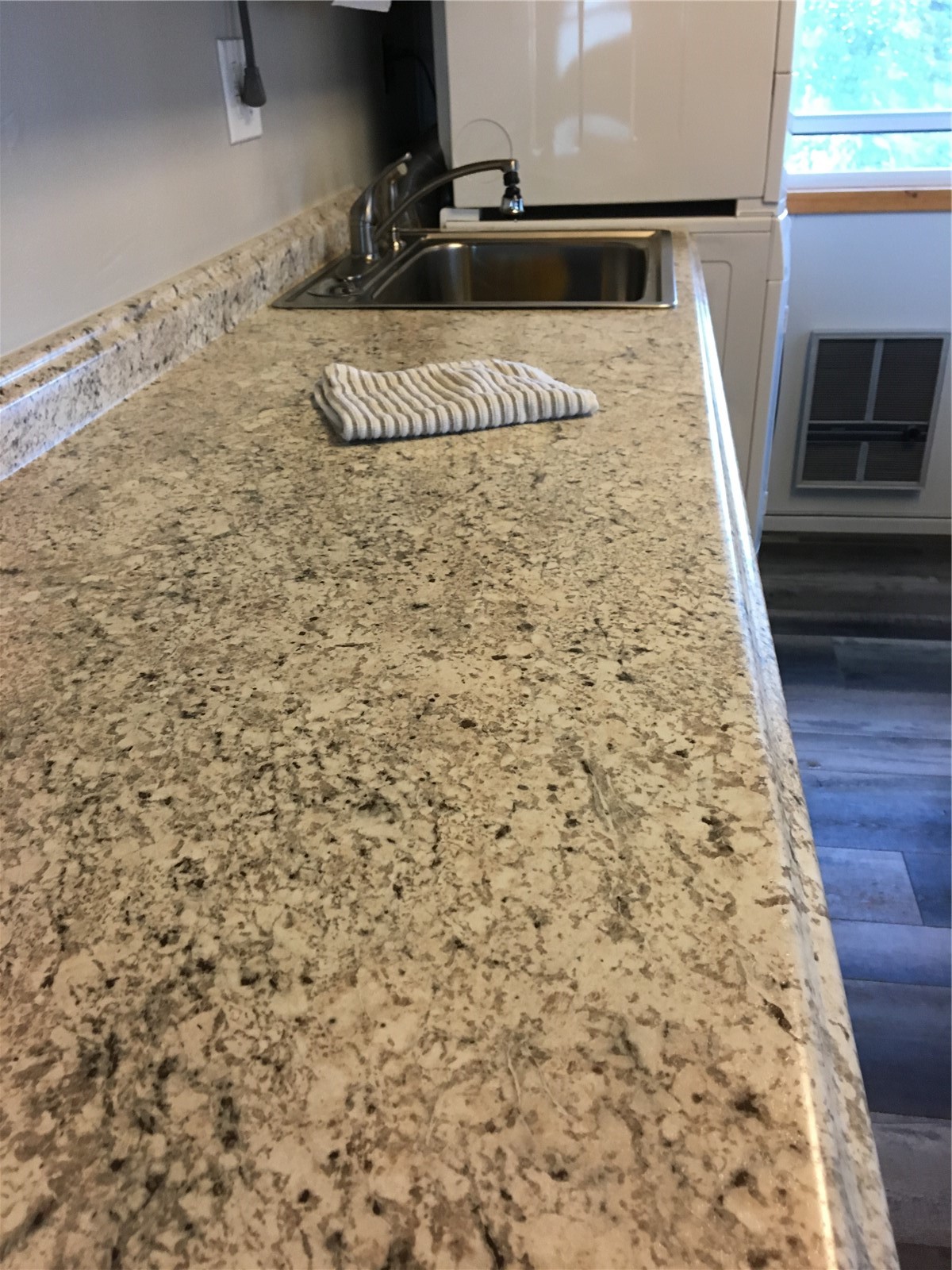 8017 Ryan Gulch Road, Unit B8 Silverthorne, CO 80498 - Photo 11 of 15 Kitchen featuring white cabinets, dark hardwood / wood-style flooring, light stone counters, and sink