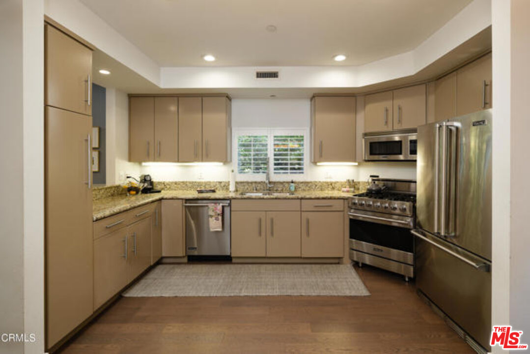 10918 Morrison Street, Unit 12 North Hollywood, CA 91601 - Photo 11 of 28 a kitchen with a refrigerator stove top oven a sink and dishwasher