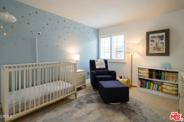 a living room with furniture and a book shelf