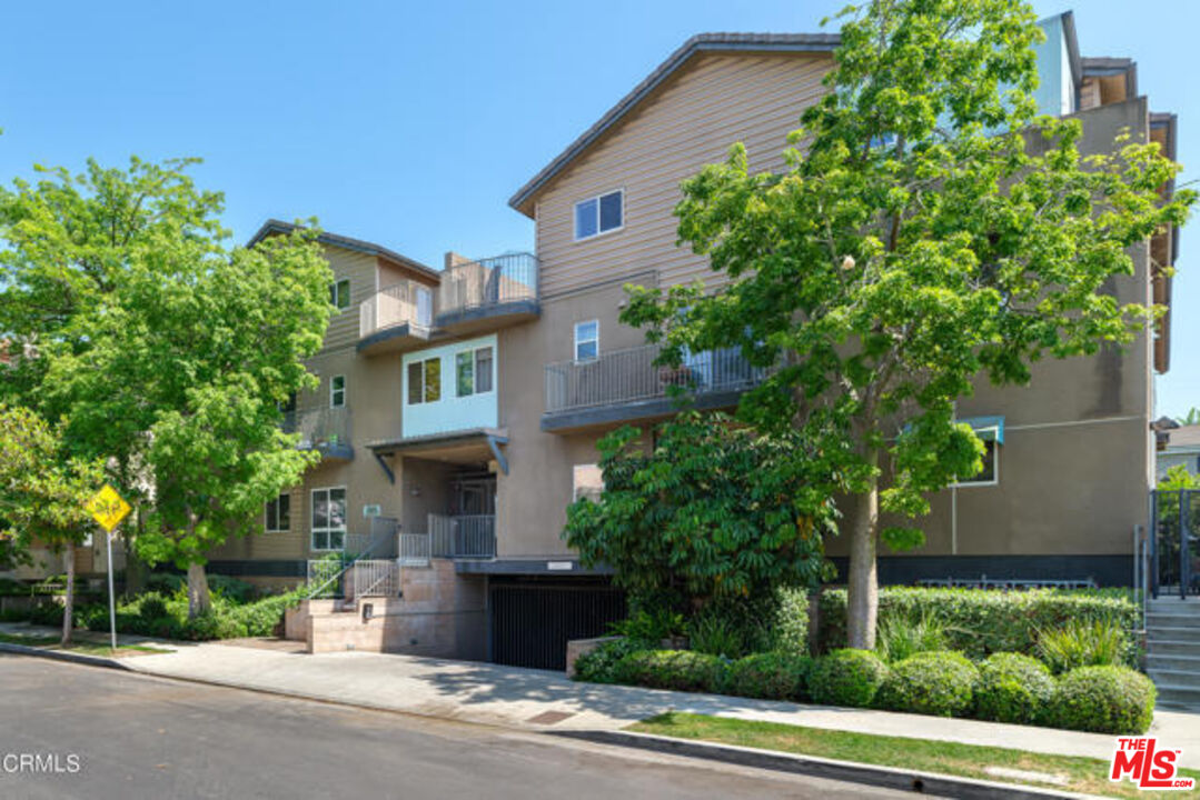 10918 Morrison Street, Unit 12 North Hollywood, CA 91601 - Photo 2 of 28 front view of a house with a tree