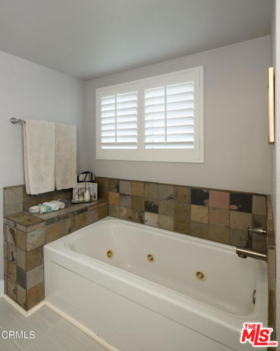 10918 Morrison Street, Unit 12 North Hollywood, CA 91601 - Photo 23 of 28 a bathroom with a bathtub and a shower