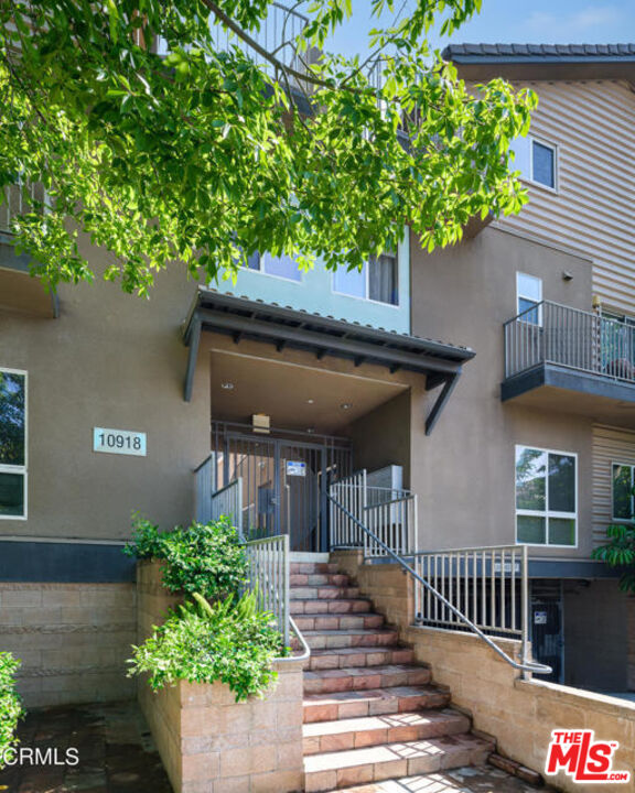 10918 Morrison Street, Unit 12 North Hollywood, CA 91601 - Photo 3 of 28 a front view of a house with a yard