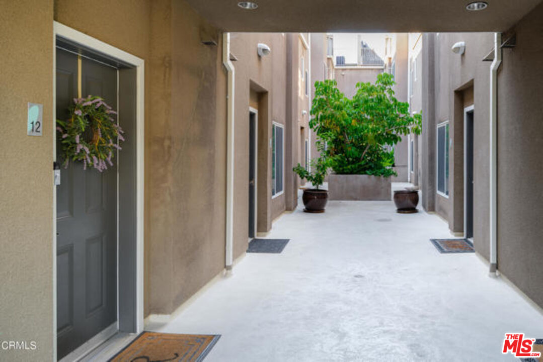 10918 Morrison Street, Unit 12 North Hollywood, CA 91601 - Photo 5 of 28 a view of a hallway with potted plants