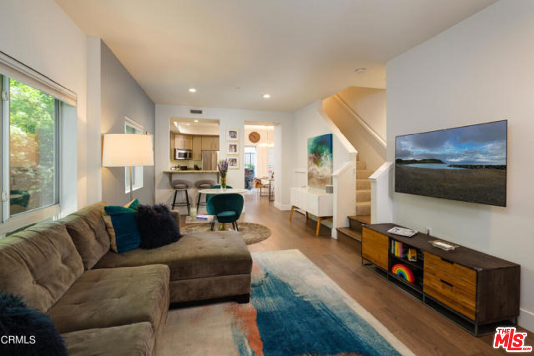 10918 Morrison Street, Unit 12 North Hollywood, CA 91601 - Photo 6 of 28 a living room with furniture and a flat screen tv