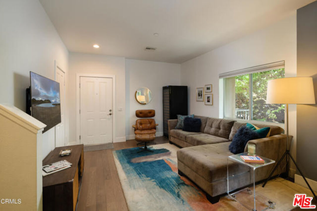 10918 Morrison Street, Unit 12 North Hollywood, CA 91601 - Photo 7 of 28 a living room with furniture and a flat screen tv