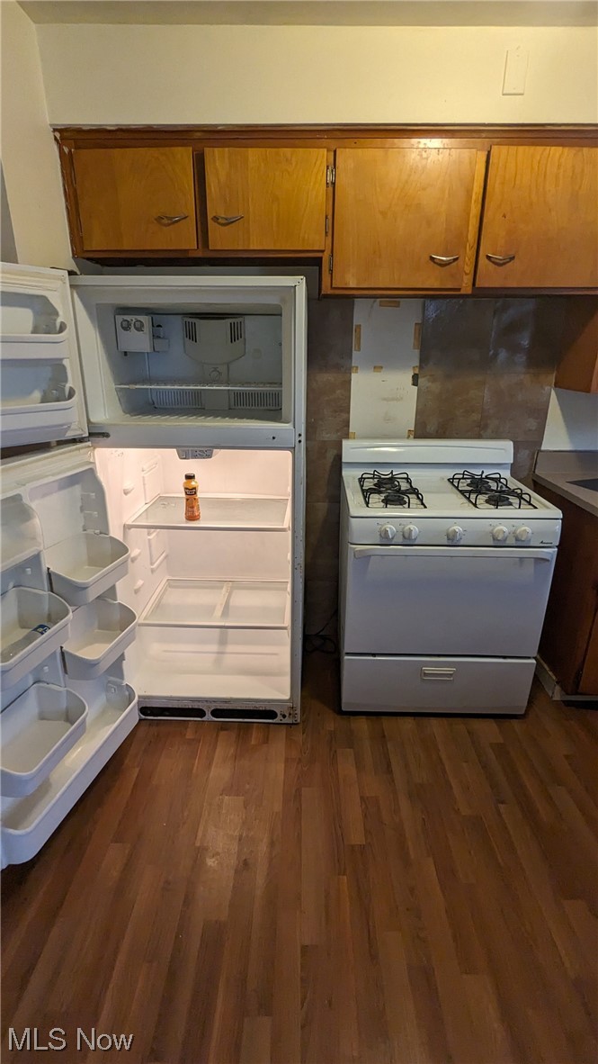 1470 Babbitt Road Euclid, OH 44117 - Photo 27 of 34 Kitchen featuring dark wood-type flooring, white gas range, and fridge, down