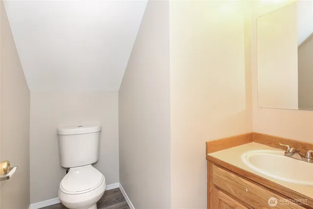 a bathroom with a toilet a sink and a mirror