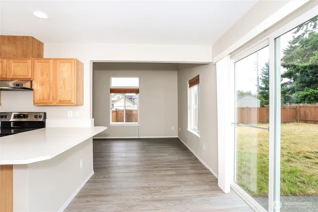 a kitchen with stainless steel appliances a sink and a large window