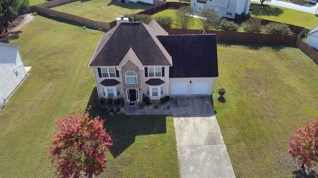 an aerial view of a house with swimming pool