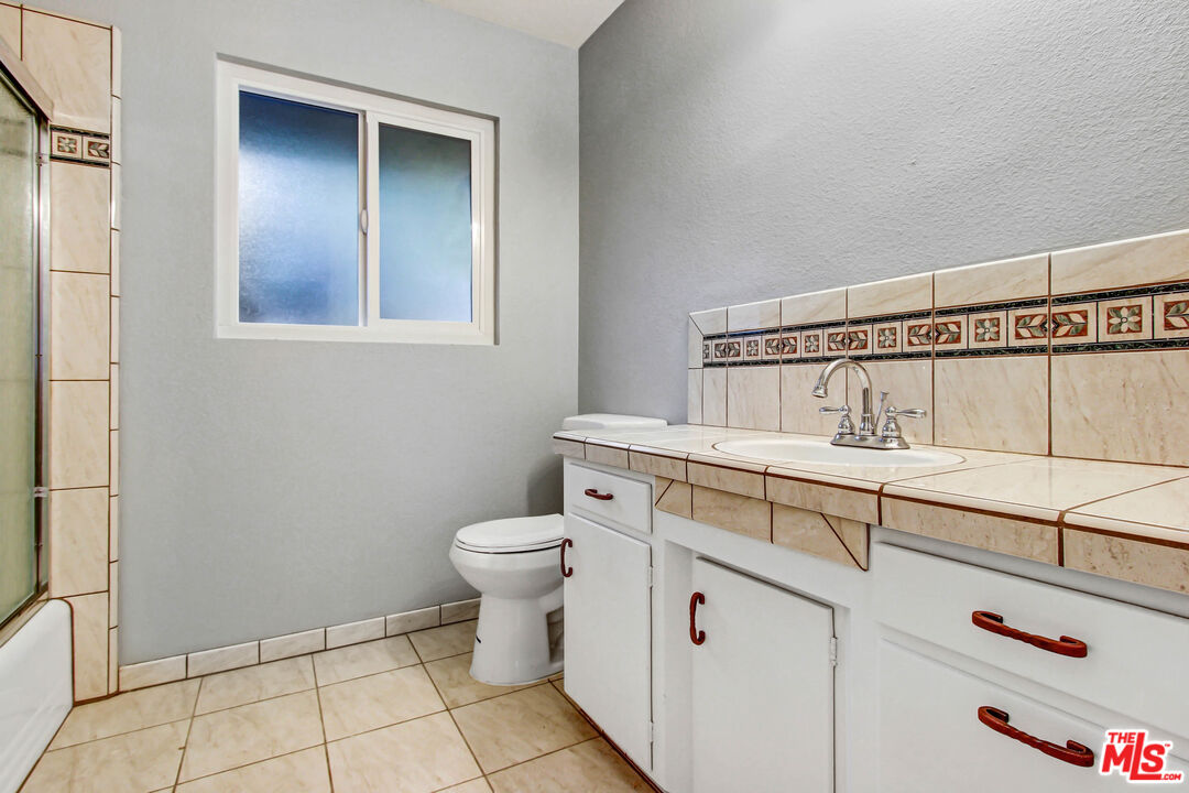 3324 Grampion Road Riverside, CA 92507 - Photo 3 of 11 a bathroom with a toilet sink and vanity