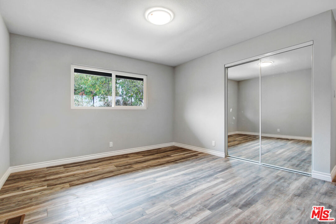 3324 Grampion Road Riverside, CA 92507 - Photo 4 of 11 an empty room with wooden floor and windows
