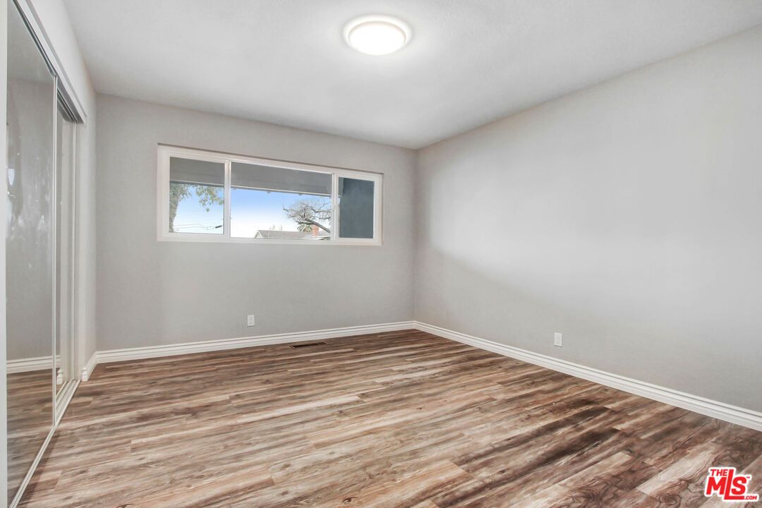 3324 Grampion Road Riverside, CA 92507 - Photo 5 of 11 a view of an empty room with wooden floor and a window