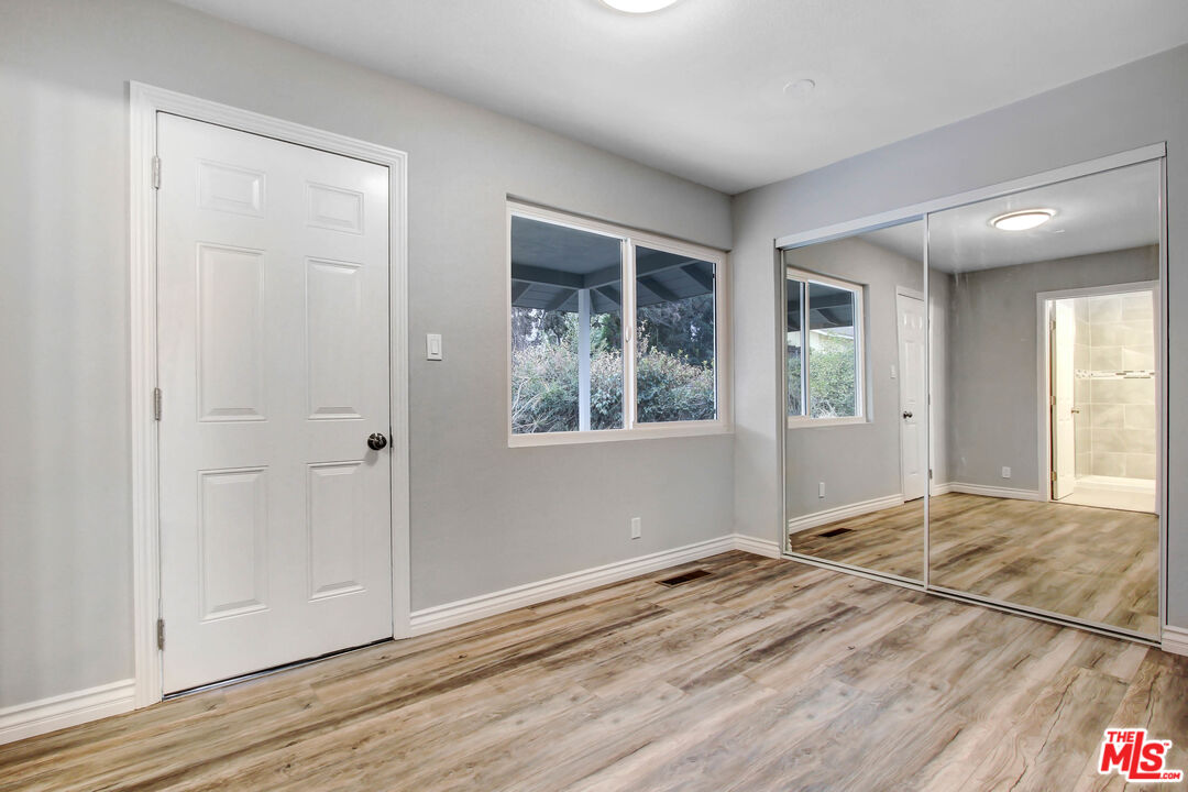 3324 Grampion Road Riverside, CA 92507 - Photo 7 of 11 a view of an empty room with wooden floor and a window