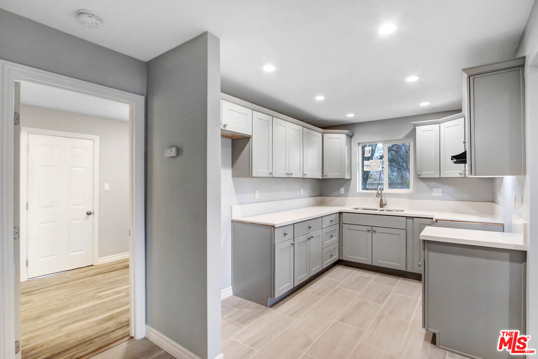 3324 Grampion Road Riverside, CA 92507 - Photo 9 of 11 a kitchen with white cabinets appliances and sink