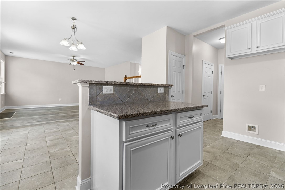 50 Huzzas Circle Cameron, NC 28326 - Photo 13 of 39 a kitchen with granite countertop a sink cabinets and stainless steel appliances