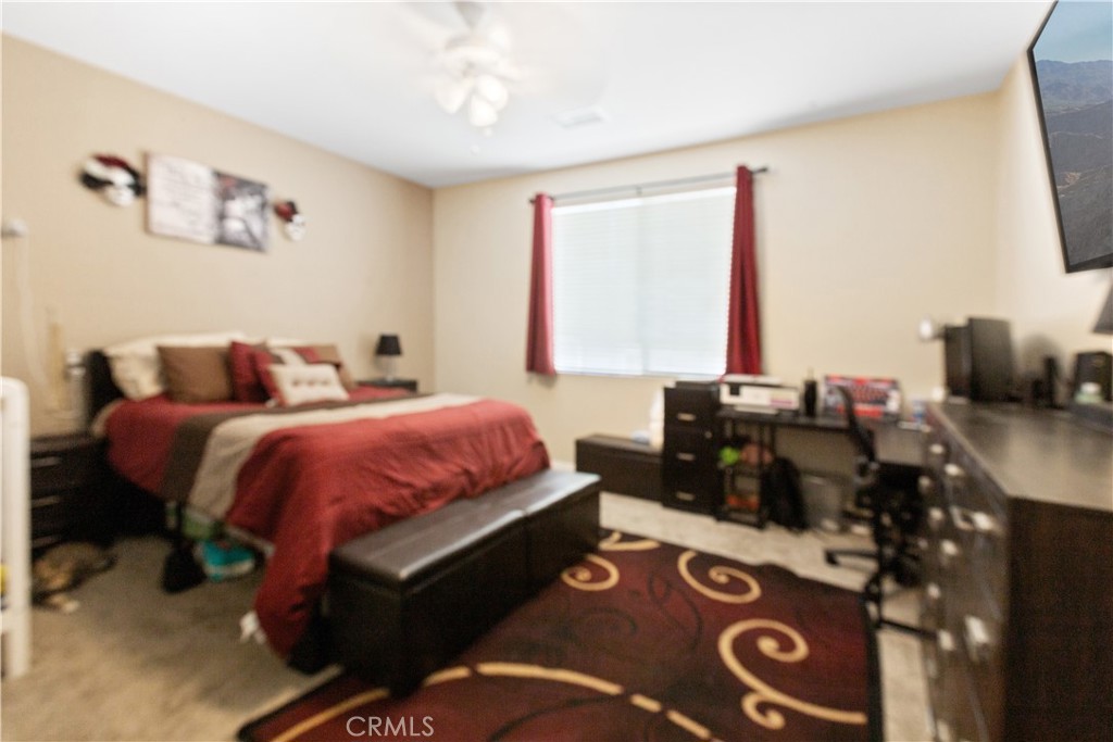 11643 Raptor Lane Desert Hot Springs, CA 92240 - Photo 12 of 37 a bed room with a bed and a television