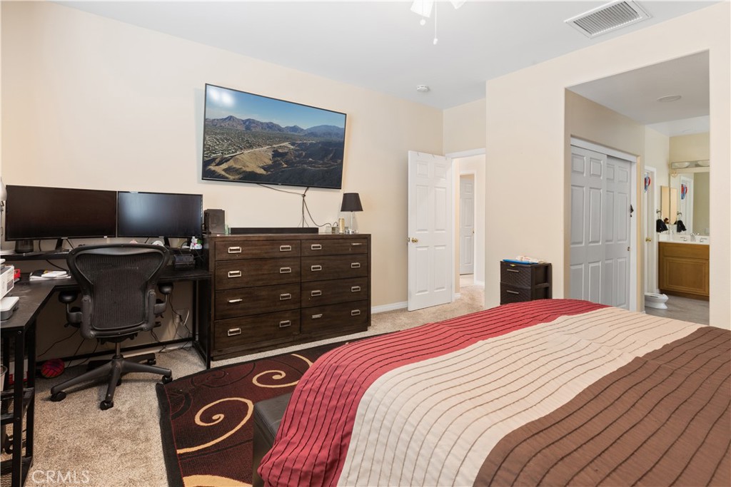 11643 Raptor Lane Desert Hot Springs, CA 92240 - Photo 13 of 37 a bedroom with a bed and a flat screen tv