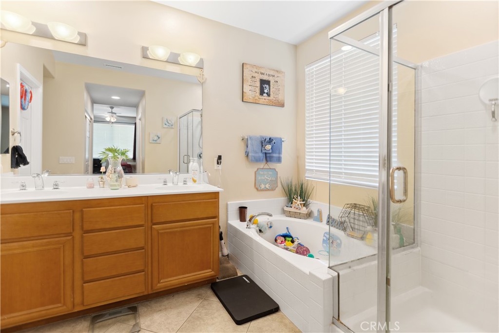11643 Raptor Lane Desert Hot Springs, CA 92240 - Photo 16 of 37 a bathroom with a tub sink and mirror