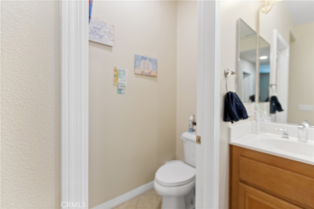 11643 Raptor Lane Desert Hot Springs, CA 92240 - Photo 17 of 37 a bathroom with a granite countertop sink toilet and mirror