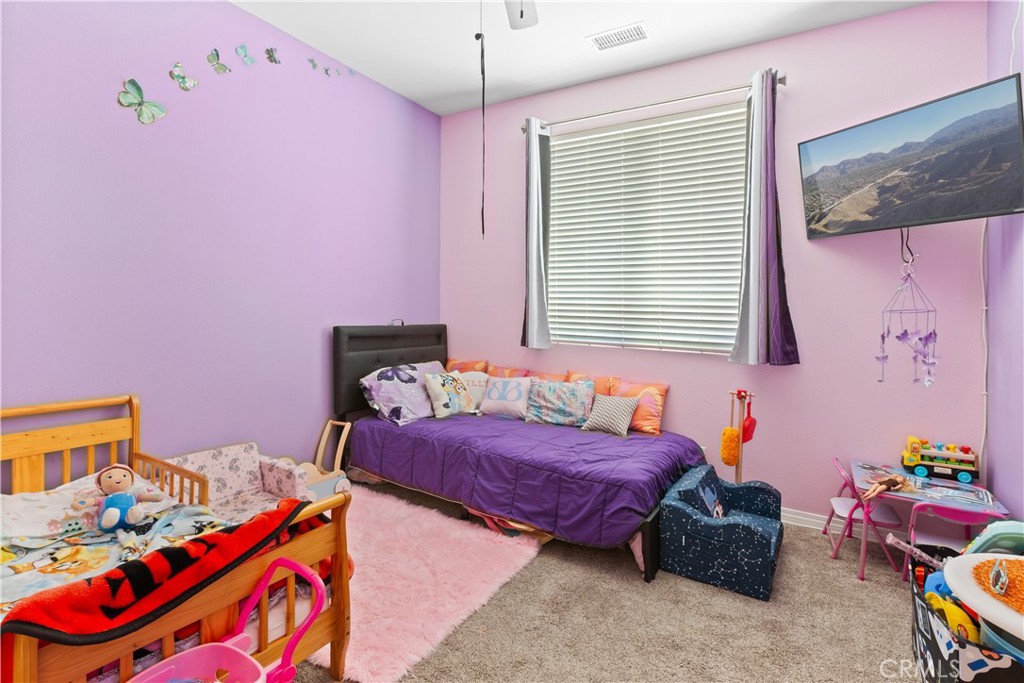11643 Raptor Lane Desert Hot Springs, CA 92240 - Photo 18 of 37 a bedroom with a bed and a window