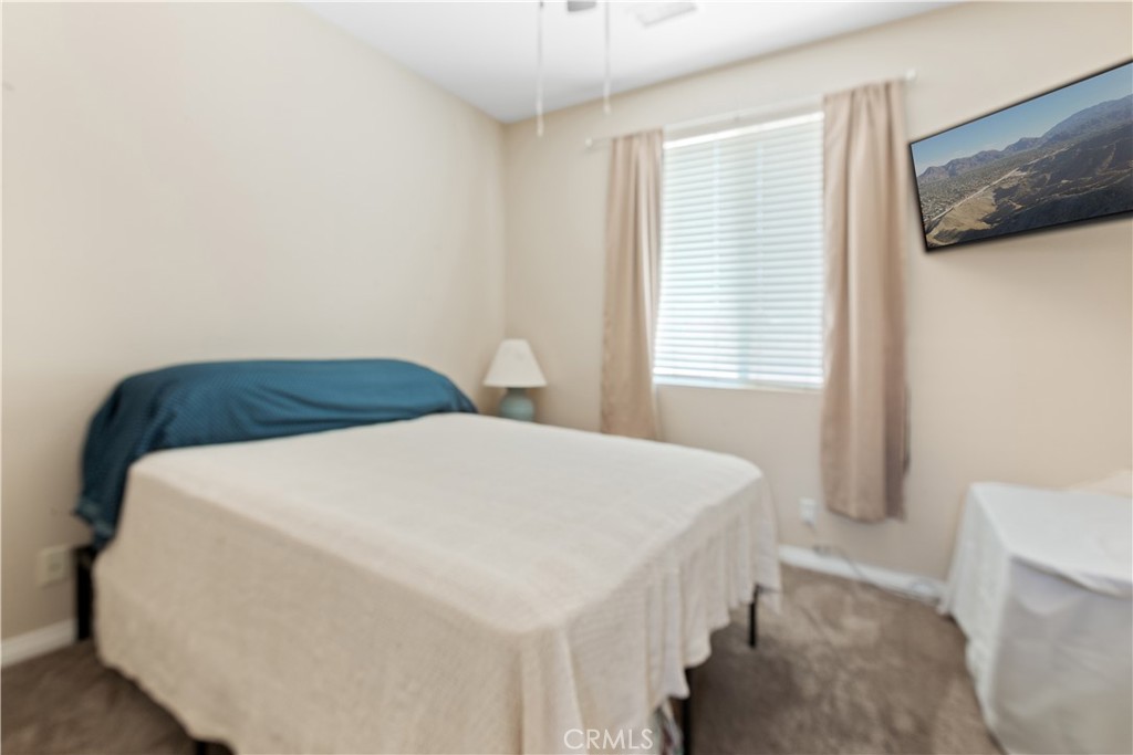 11643 Raptor Lane Desert Hot Springs, CA 92240 - Photo 23 of 37 a bedroom with a bed and a window