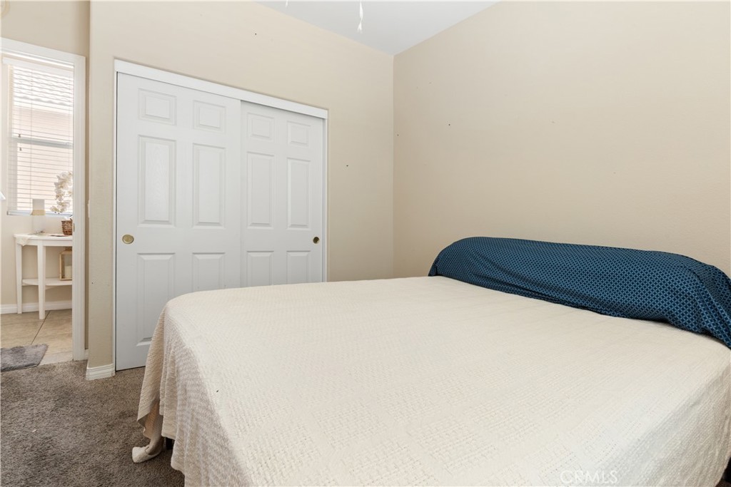 11643 Raptor Lane Desert Hot Springs, CA 92240 - Photo 24 of 37 a bedroom with a bed and a cabinets