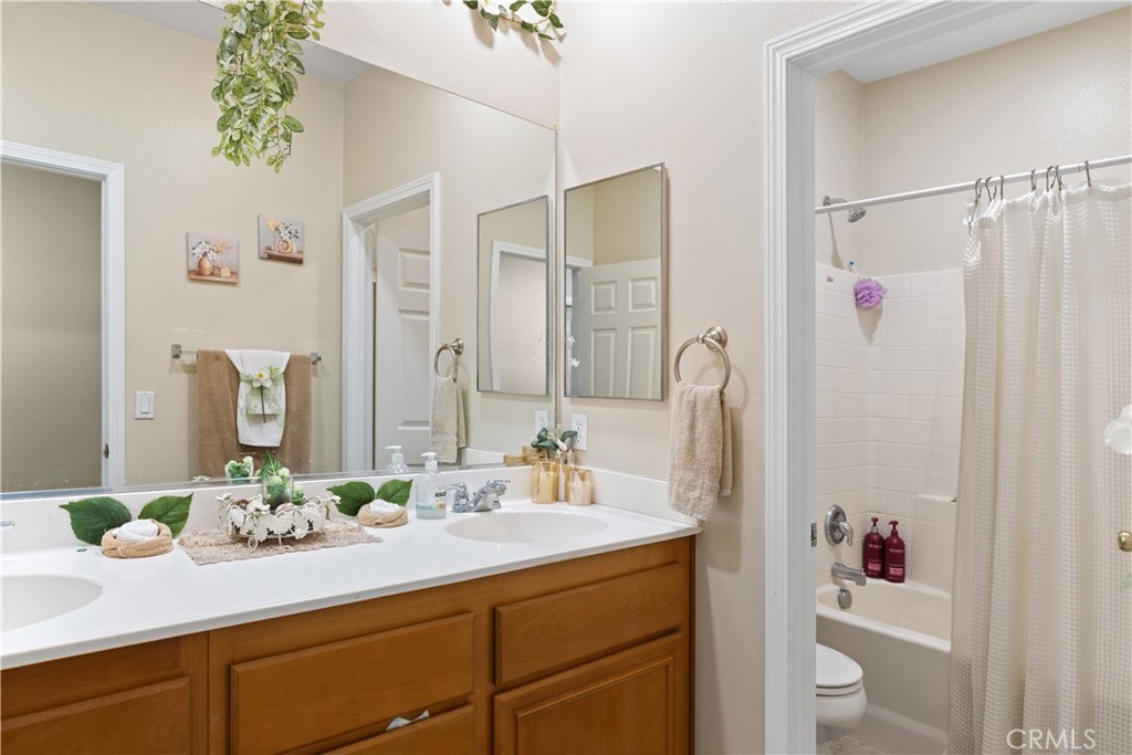 11643 Raptor Lane Desert Hot Springs, CA 92240 - Photo 25 of 37 a bathroom with a granite countertop sink a shower and a mirror
