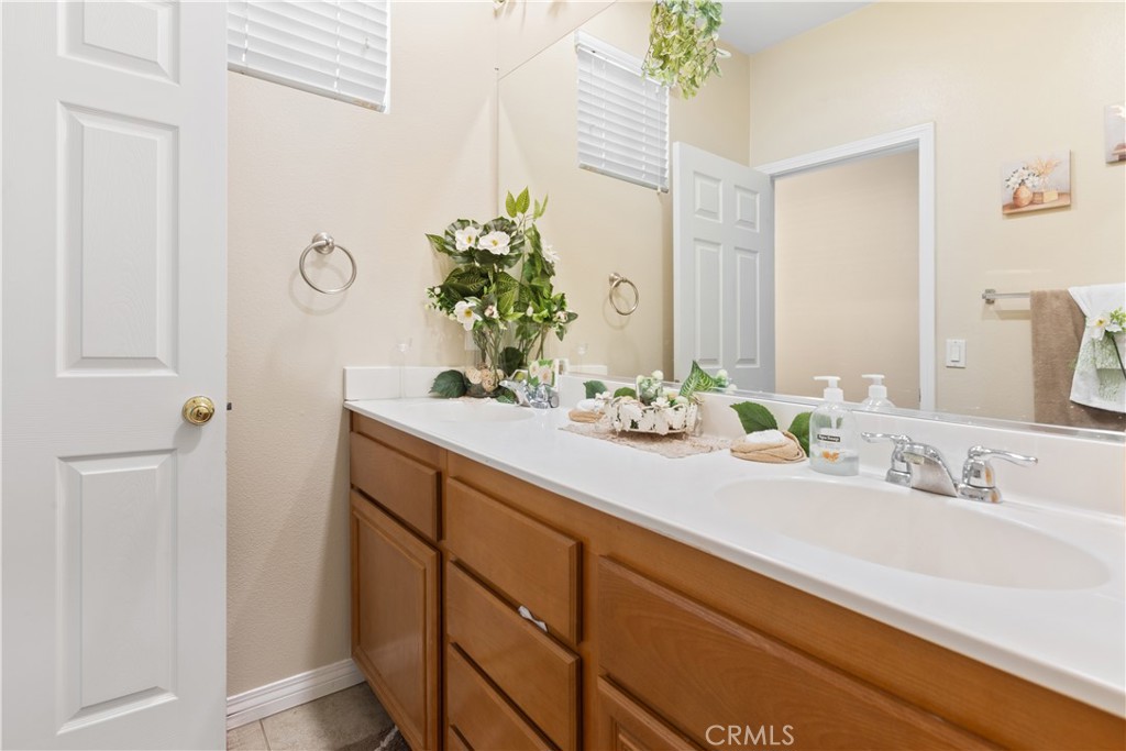 11643 Raptor Lane Desert Hot Springs, CA 92240 - Photo 27 of 37 a bathroom with a sink vanity and a mirror