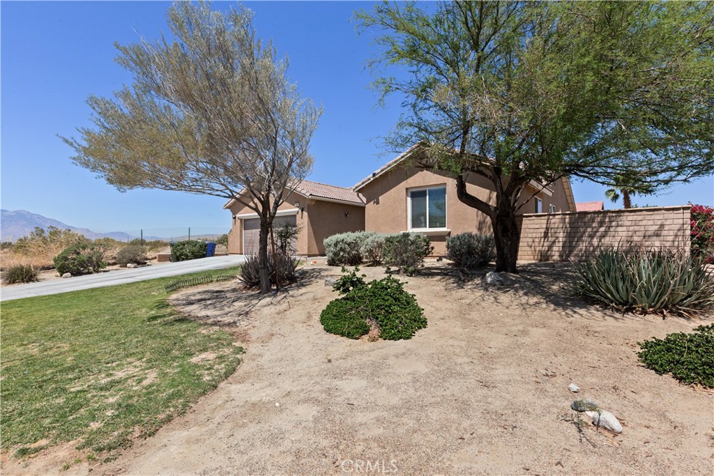 11643 Raptor Lane Desert Hot Springs, CA 92240 - Photo 32 of 37 a view of a house with backyard and garden