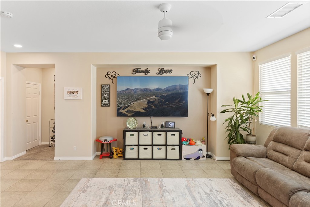 11643 Raptor Lane Desert Hot Springs, CA 92240 - Photo 4 of 37 a living room with furniture and a flat screen tv
