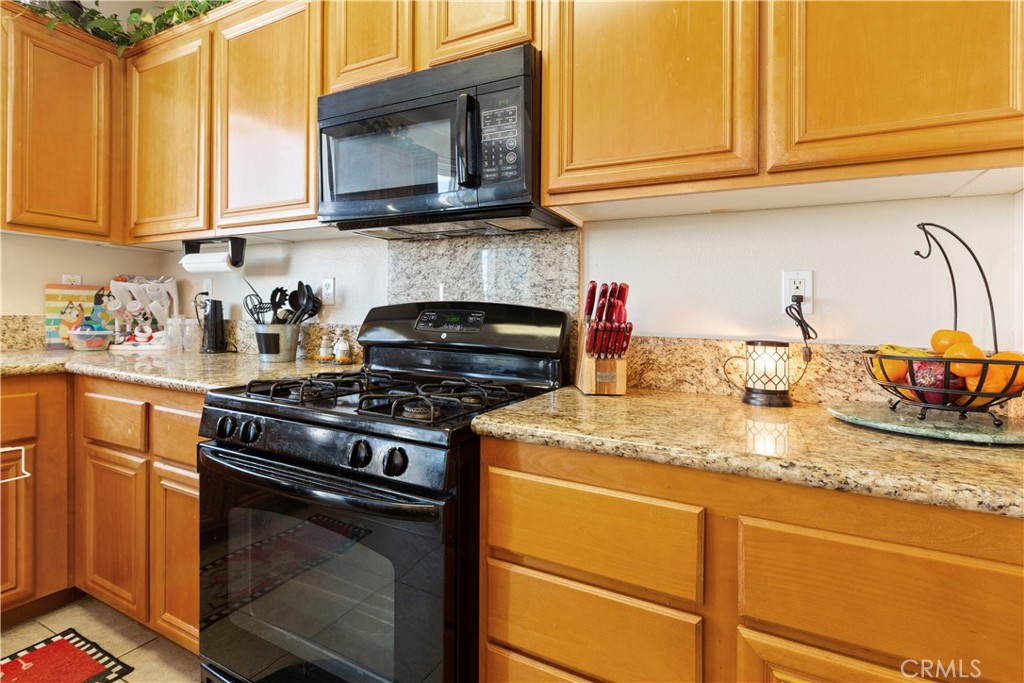 11643 Raptor Lane Desert Hot Springs, CA 92240 - Photo 9 of 37 a kitchen with granite countertop cabinets stainless steel appliances and a sink