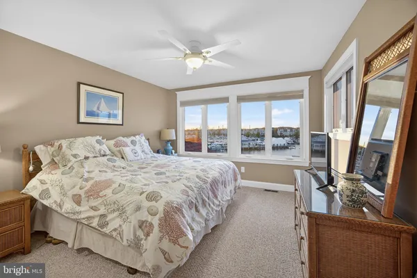 a spacious bedroom with a large bed and a large window