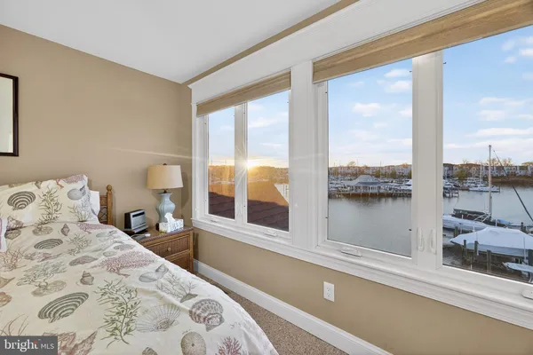 a bedroom with a large bed and a large window with outer view