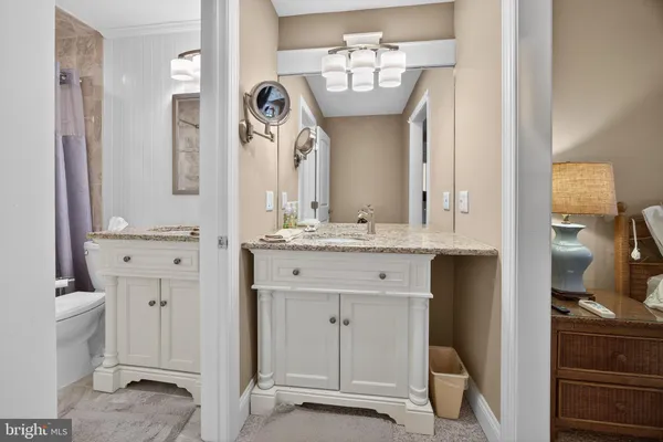 a bathroom with a double vanity sink and a mirror