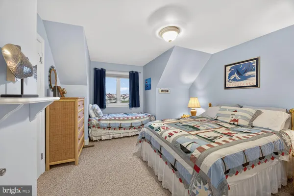 a bedroom with bed and a large mirror