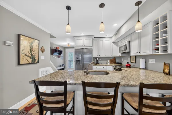 a view of kitchen with granite countertop cabinets and wooden floor
