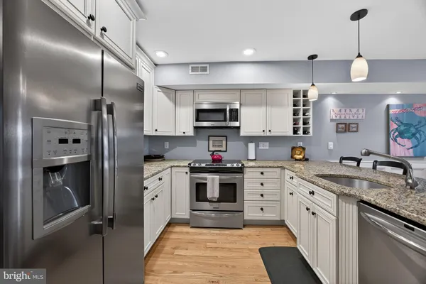a kitchen with cabinets and stainless steel appliances