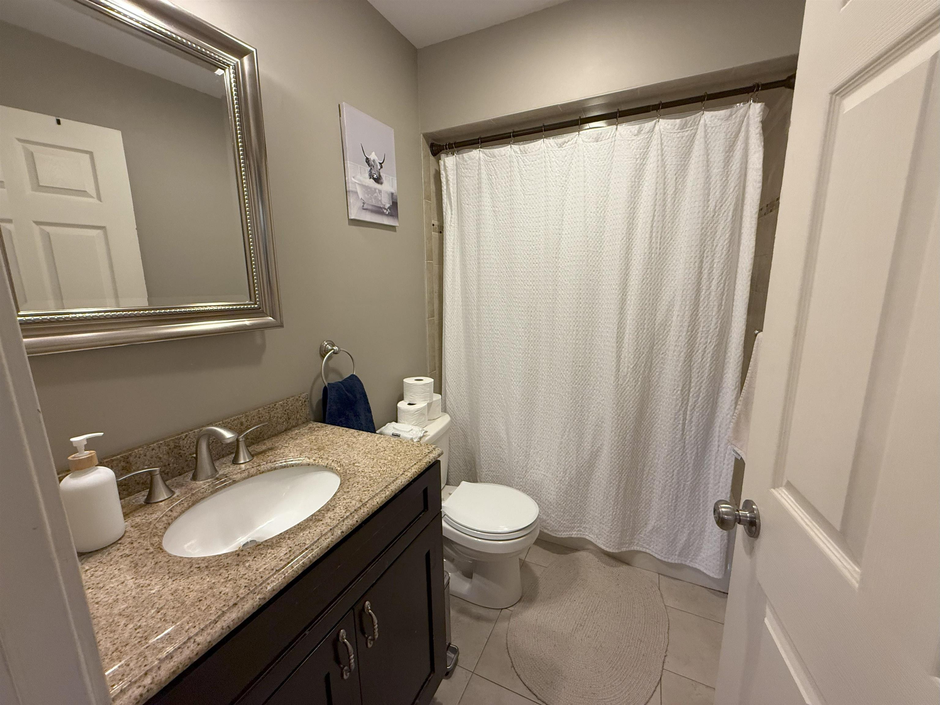 45 Garfield Place, Unit 1 (1ST FLOOR) Ridgewood, NJ 07450 - Photo 14 of 33 a bathroom with a granite countertop sink and a mirror