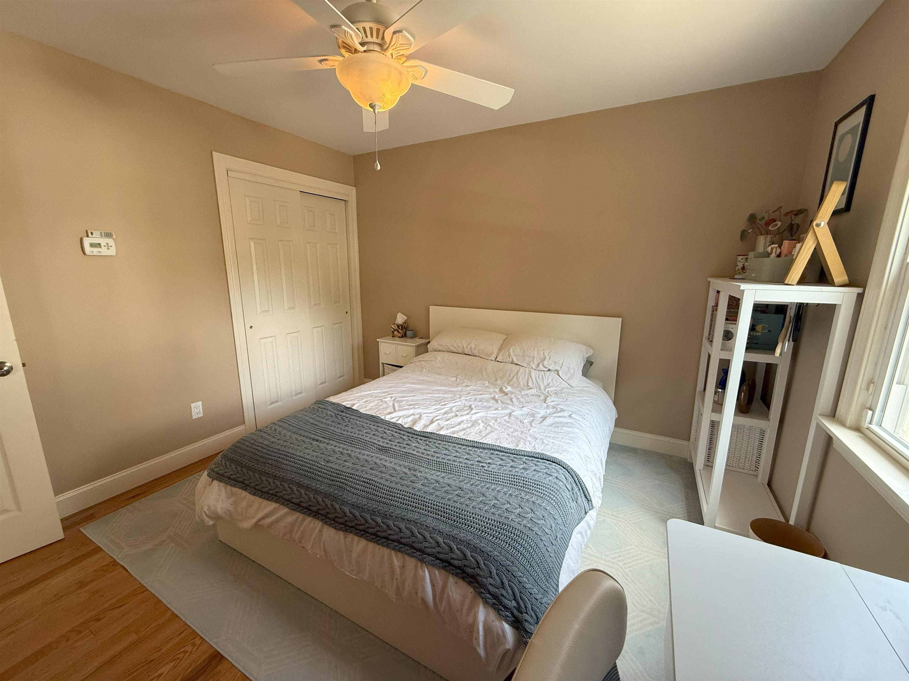 45 Garfield Place, Unit 1 (1ST FLOOR) Ridgewood, NJ 07450 - Photo 17 of 33 a bedroom with a bed and a chandelier