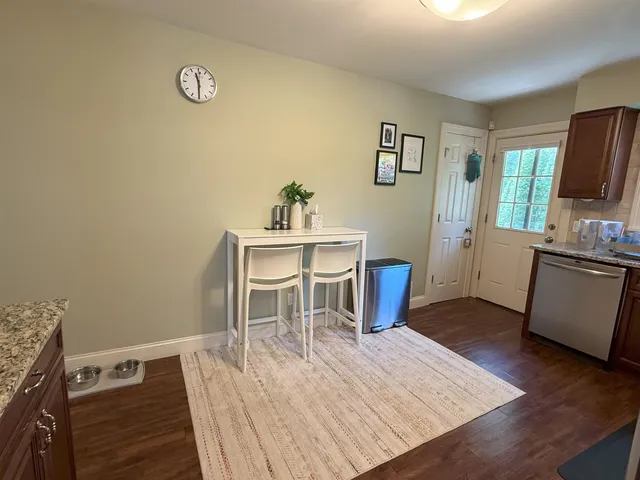 a kitchen with granite countertop wooden cabinets a sink and dishwasher