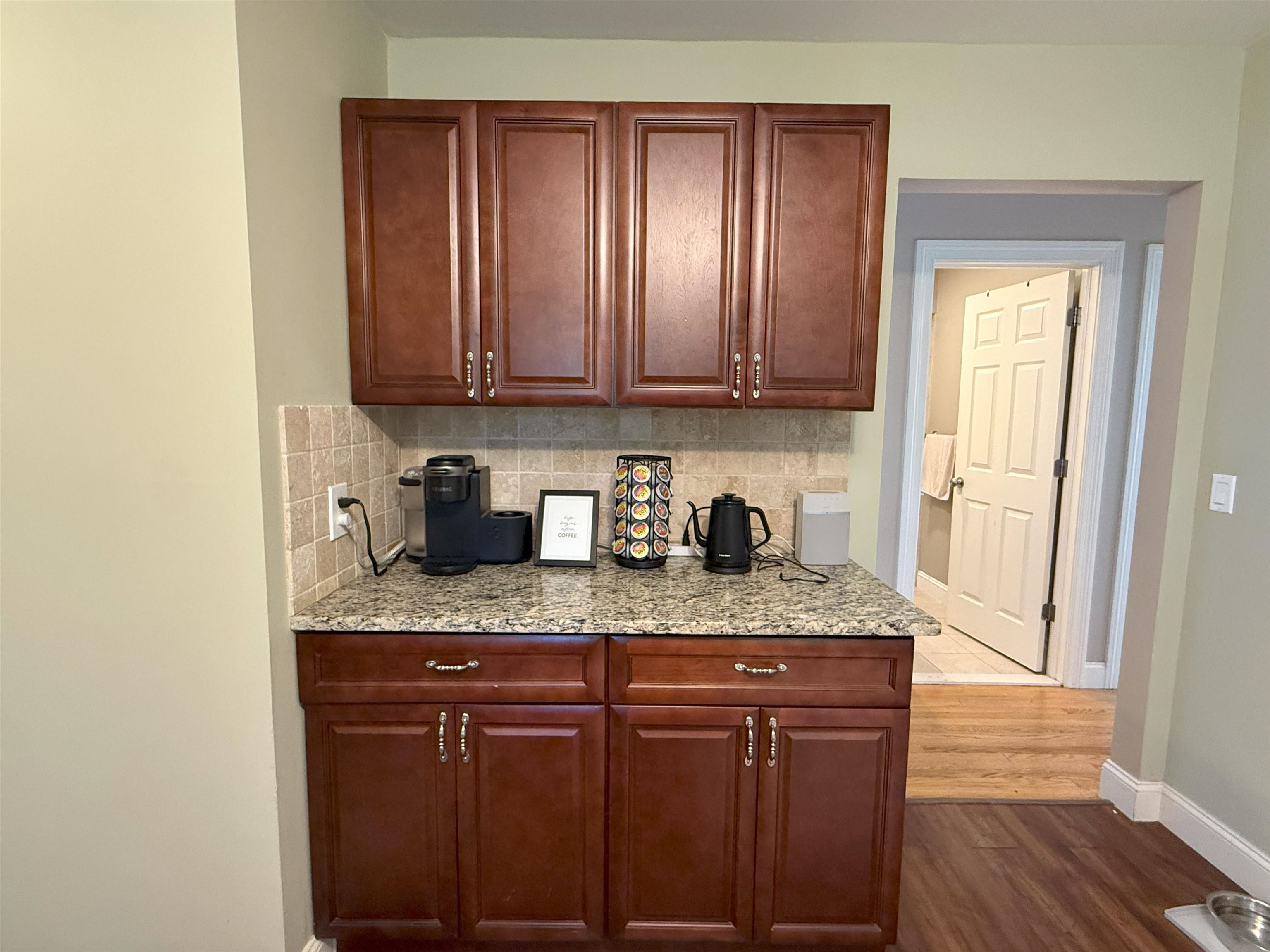 45 Garfield Place, Unit 1 (1ST FLOOR) Ridgewood, NJ 07450 - Photo 9 of 33 a kitchen with granite countertop wooden cabinets a sink and dishwasher