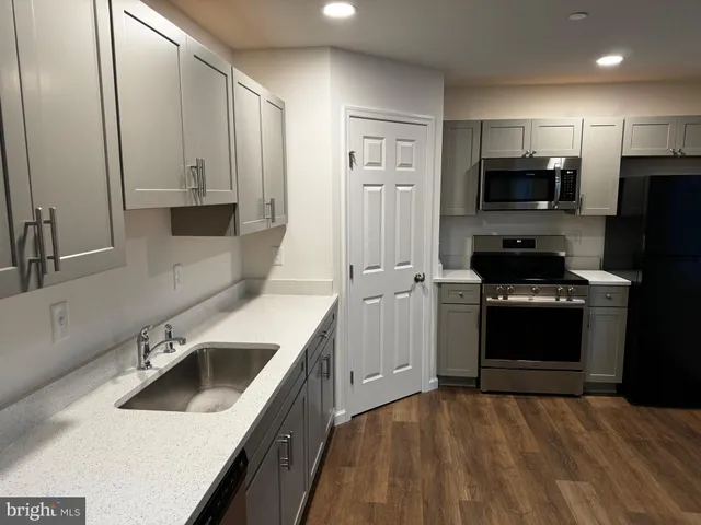 a kitchen with a sink stove and refrigerator