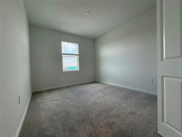 an empty room with a window and a fireplace