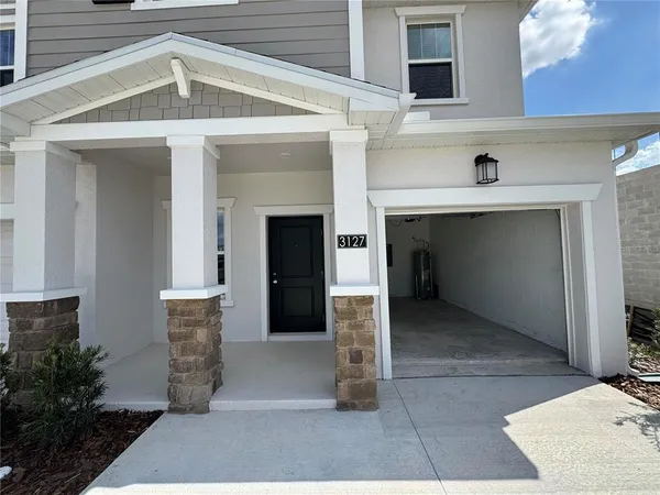 a front view of a house with a garage