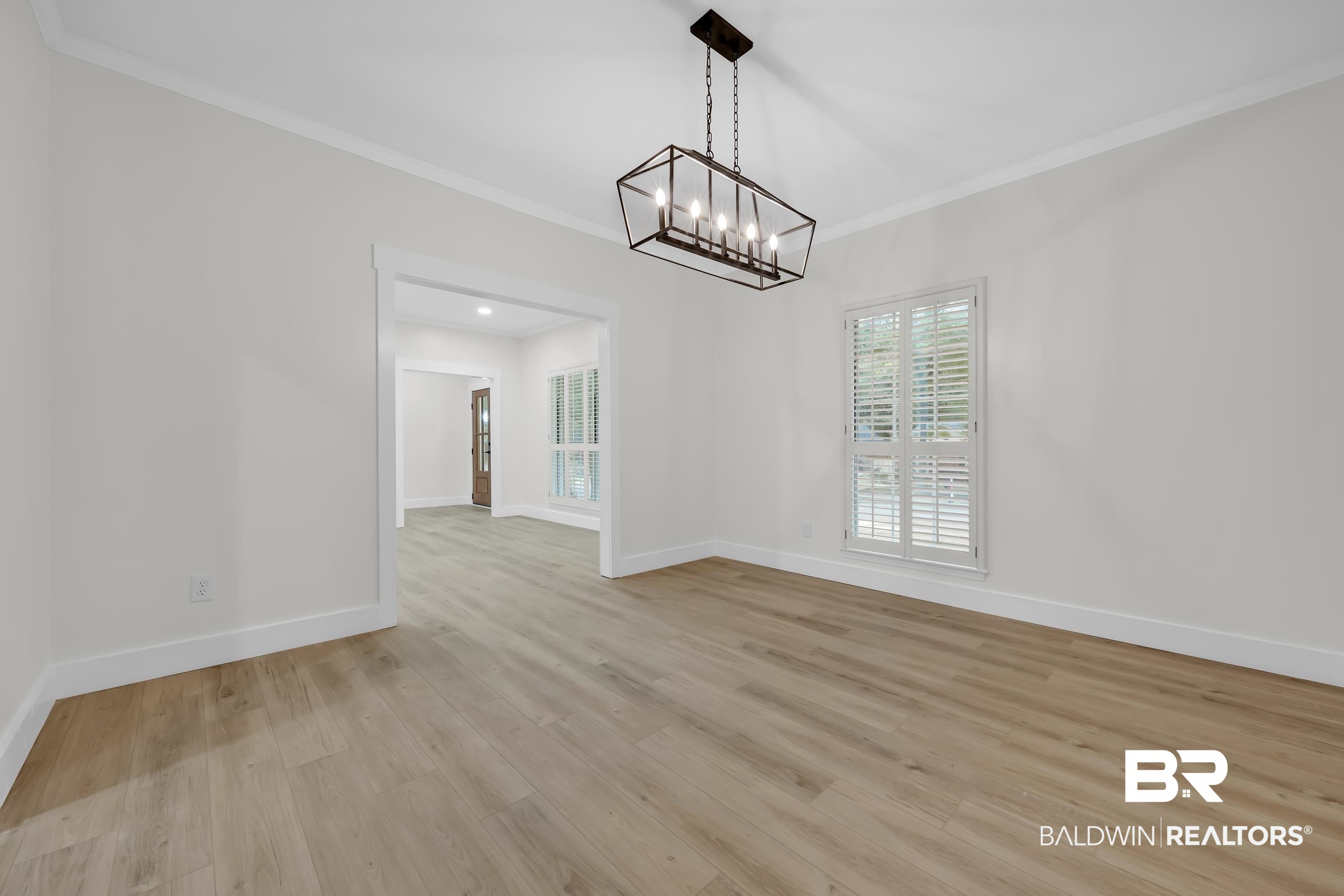 4924 Brooke Court Mobile, AL 36618 - Photo 8 of 34 Unfurnished dining area featuring light wood-type flooring, ornamental molding, and a chandelier