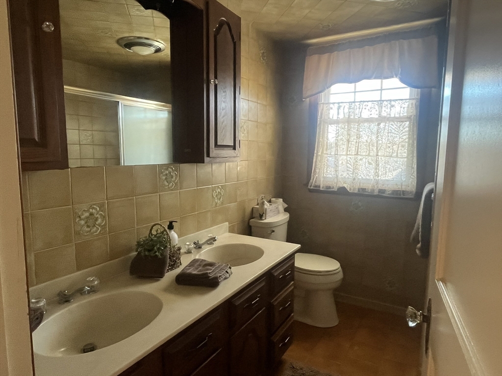 11 Sumner Road Salem, MA 01970 - Photo 26 of 37 a bathroom with a sink toilet and mirror