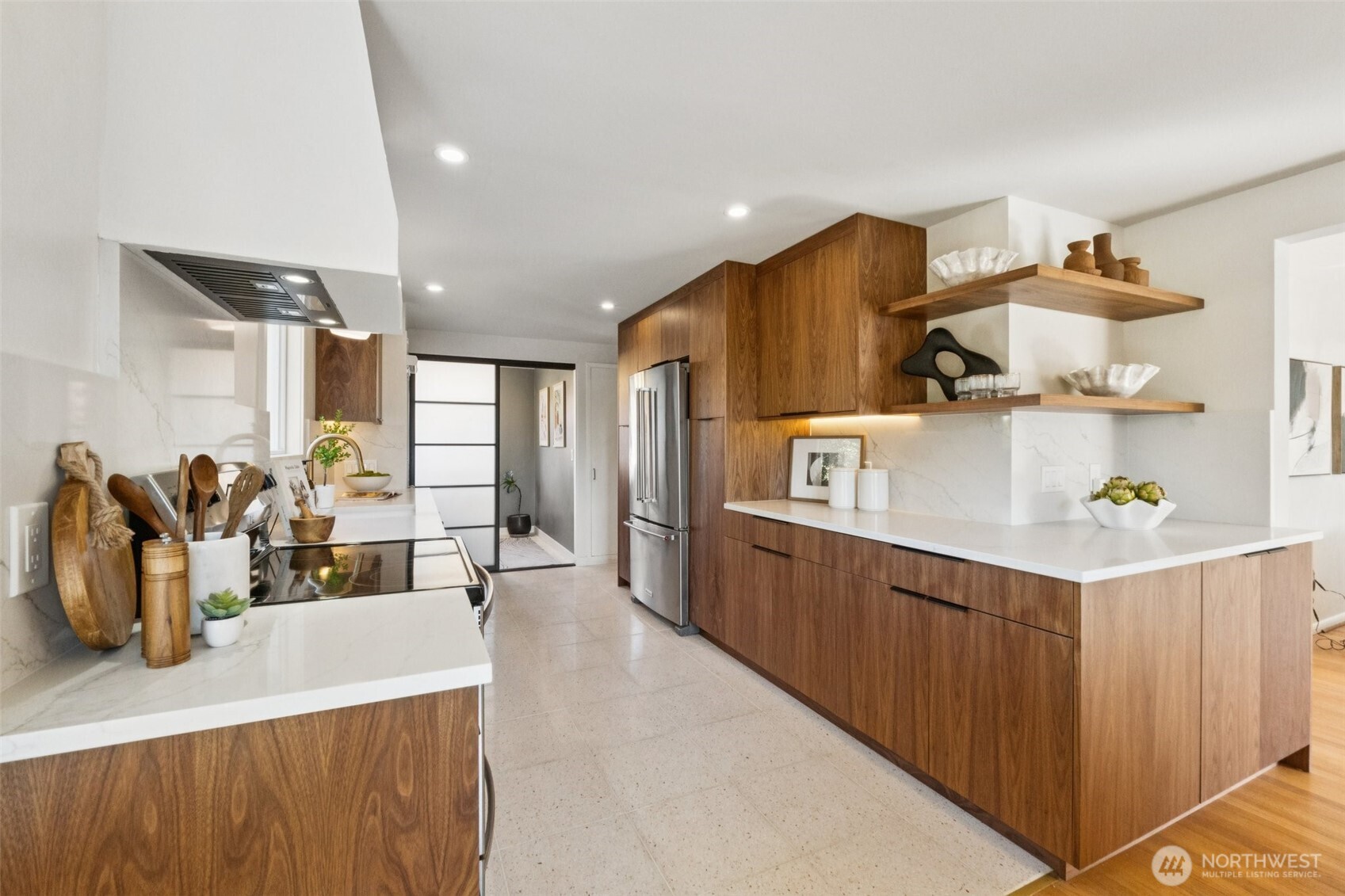 730 Northwest 73rd Street Seattle, WA 98117 - Photo 12 of 39 a kitchen with stainless steel appliances wooden cabinets a center island and a refrigerator