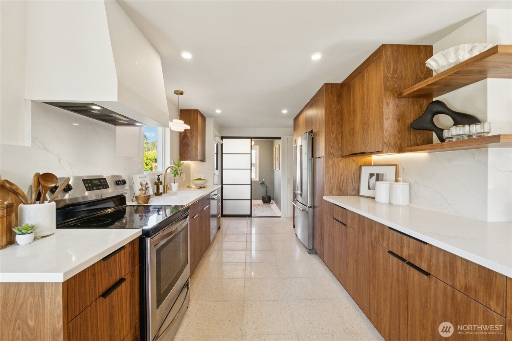 730 Northwest 73rd Street Seattle, WA 98117 - Photo 13 of 39 a large kitchen with stainless steel appliances a sink dishwasher and a refrigerator