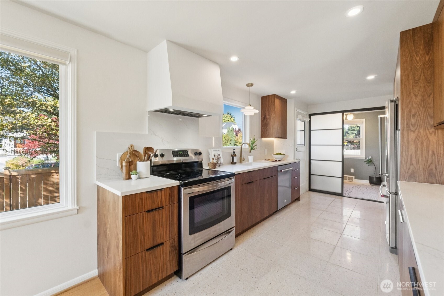 730 Northwest 73rd Street Seattle, WA 98117 - Photo 14 of 39 a kitchen with a sink stove and cabinets
